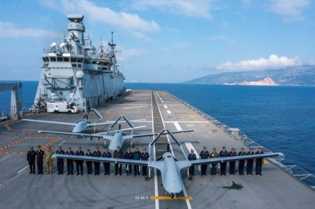 Three Bayraktar TB3 drones and military personnel stand on board TCG Anadolu during Baykar Distinguished Observer Day of the SEAWOLF 2025 Exercise in Antalya, Türkiye on May 14, 2025. (Baykar)