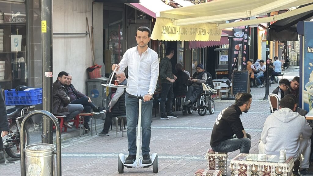 Turkish tea seller uses hoverboard to speed up deliveries